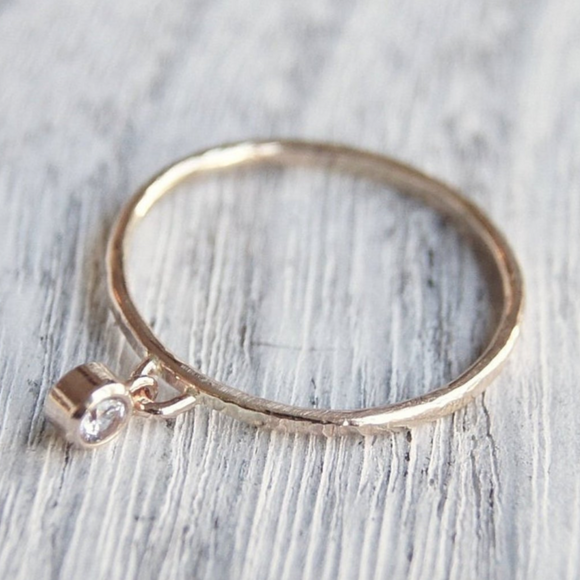 gold ring with a dangle gemstone charm